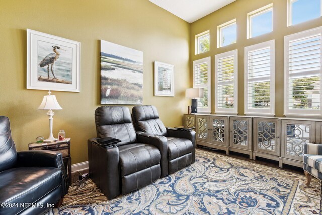 sitting room with a wealth of natural light and hardwood / wood-style flooring