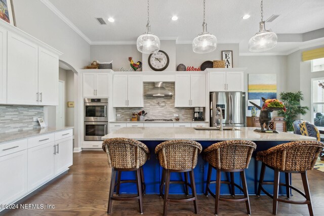 kitchen with wall chimney exhaust hood, tasteful backsplash, dark hardwood / wood-style floors, and appliances with stainless steel finishes