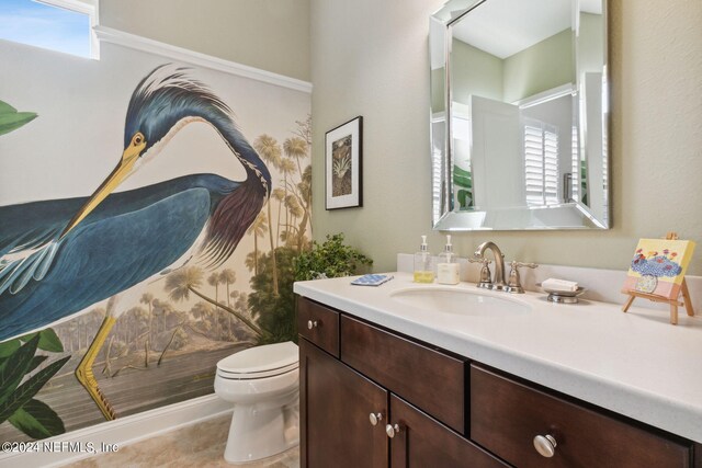 bathroom featuring tile patterned floors, vanity, a healthy amount of sunlight, and toilet