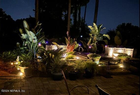 yard at night with a patio