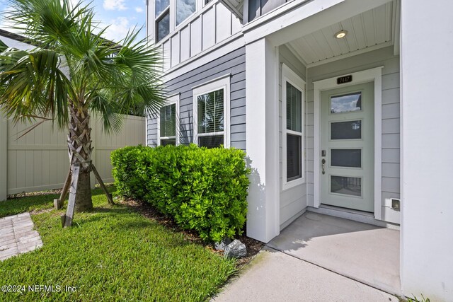 view of exterior entry featuring a yard