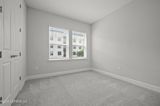 unfurnished room featuring carpet floors and a textured ceiling