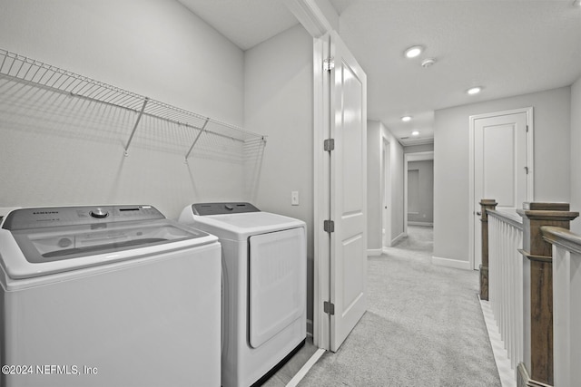 washroom featuring washing machine and clothes dryer and light colored carpet