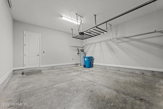 garage featuring a garage door opener and electric water heater