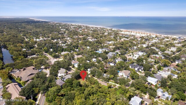 drone / aerial view featuring a beach view and a water view