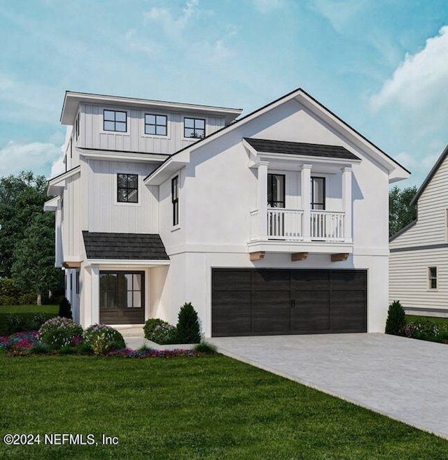 view of front facade featuring a balcony, a garage, and a front yard