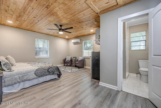 bedroom with ensuite bath, wood ceiling, ceiling fan, a wall mounted AC, and hardwood / wood-style flooring