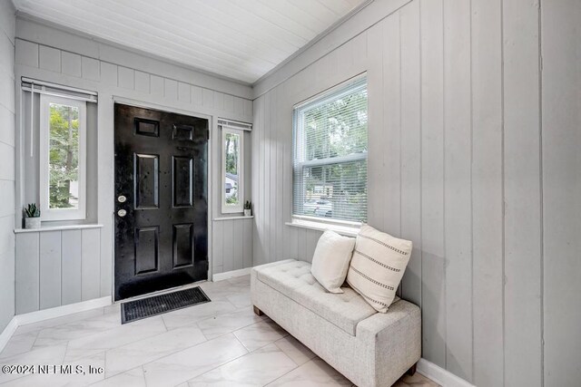 foyer entrance with a healthy amount of sunlight and light tile patterned floors