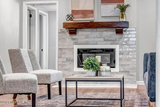 living area featuring hardwood / wood-style flooring and a fireplace