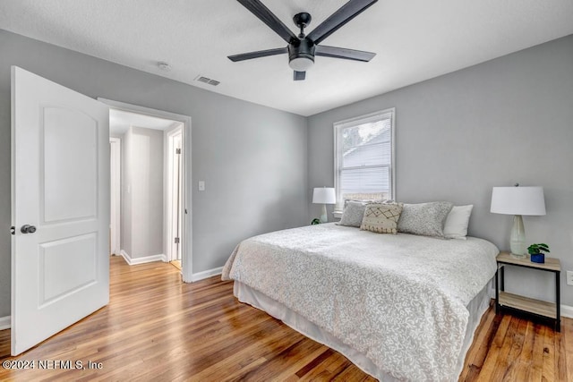 bedroom with hardwood / wood-style flooring and ceiling fan