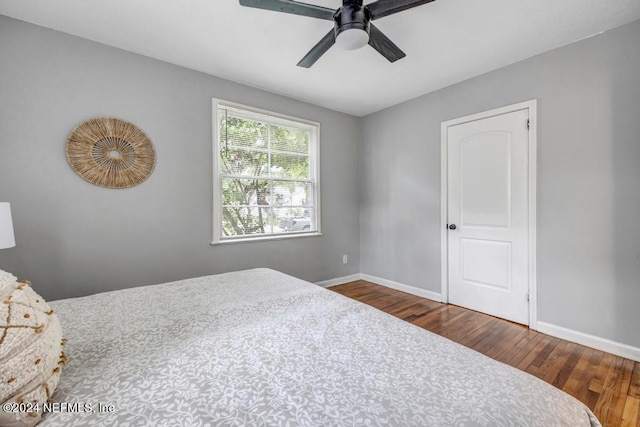 bedroom with ceiling fan and dark hardwood / wood-style floors