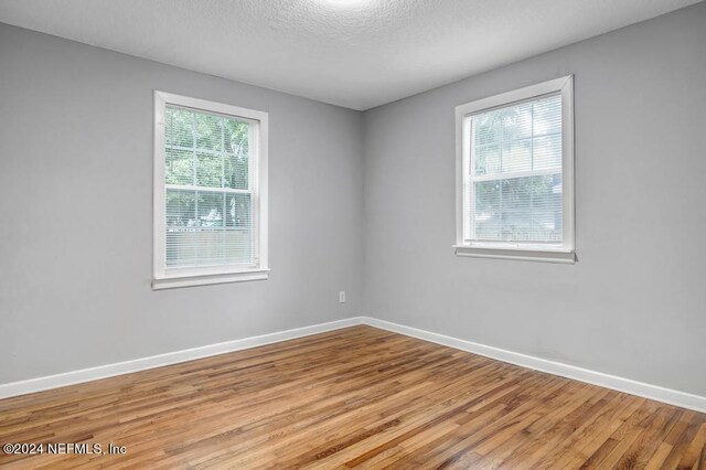 unfurnished room featuring hardwood / wood-style floors