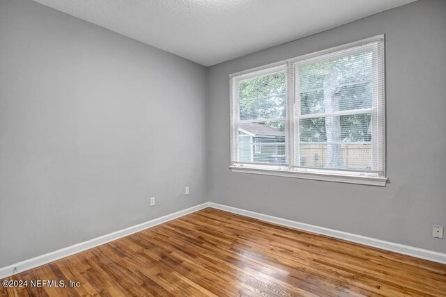 spare room featuring hardwood / wood-style floors