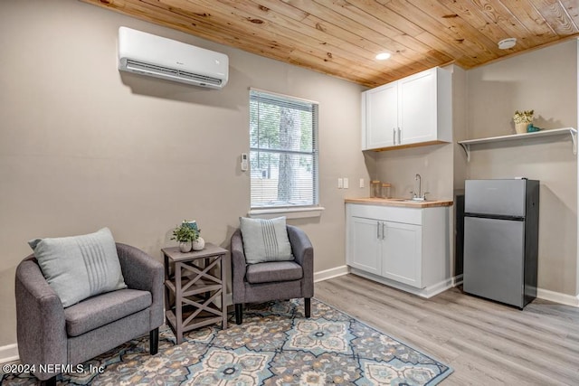 living area featuring sink, wood ceiling, an AC wall unit, and light wood-type flooring