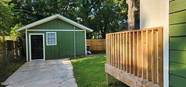 view of outbuilding with a lawn