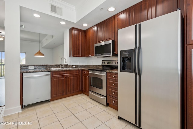 kitchen with dark stone counters, sink, appliances with stainless steel finishes, a tray ceiling, and crown molding