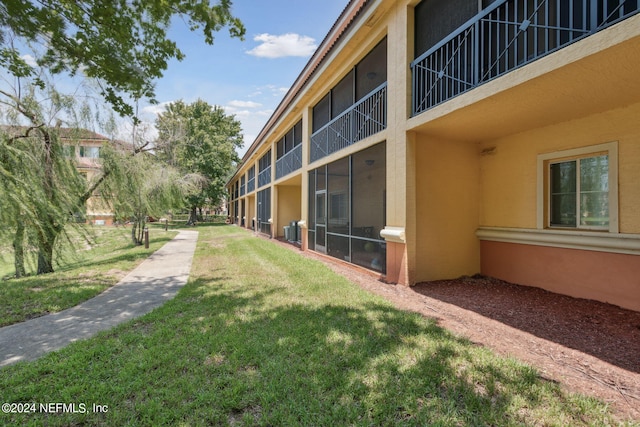 view of yard featuring a balcony and central air condition unit