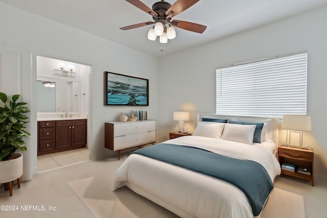 carpeted bedroom featuring sink, ceiling fan, and ensuite bathroom