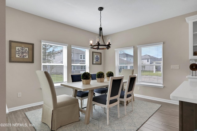 dining space featuring a chandelier, hardwood / wood-style flooring, and plenty of natural light