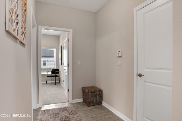 hallway with light hardwood / wood-style flooring