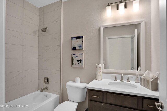 bathroom with toilet, tub / shower combination, and vanity