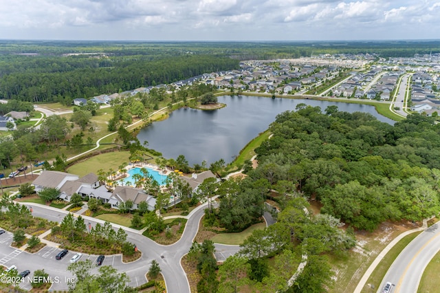 aerial view featuring a forest view and a water view