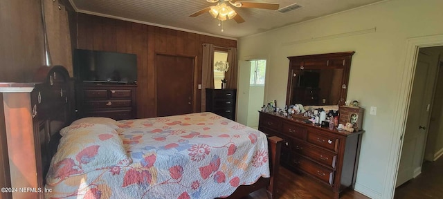 bedroom featuring ceiling fan and wood walls