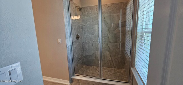 bathroom with a shower with shower door