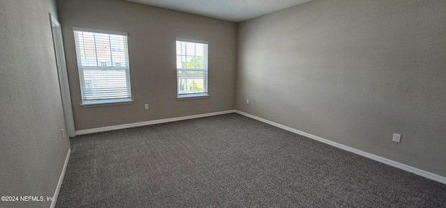 empty room with dark carpet