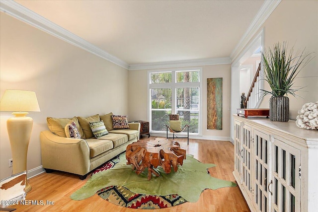 living area featuring ornamental molding, wood finished floors, and baseboards