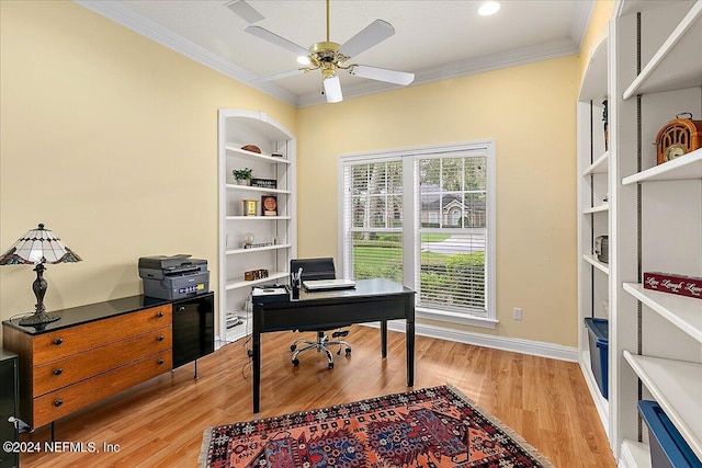 office space with baseboards, light wood-style flooring, built in features, and crown molding