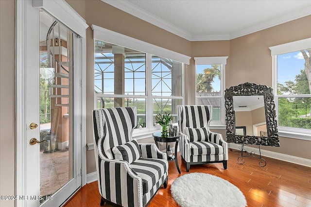 interior space with crown molding, baseboards, and wood finished floors