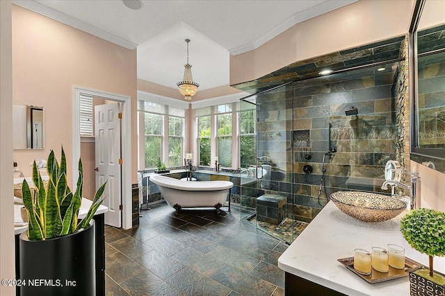 full bath with a stall shower, stone tile floors, vanity, a freestanding bath, and crown molding