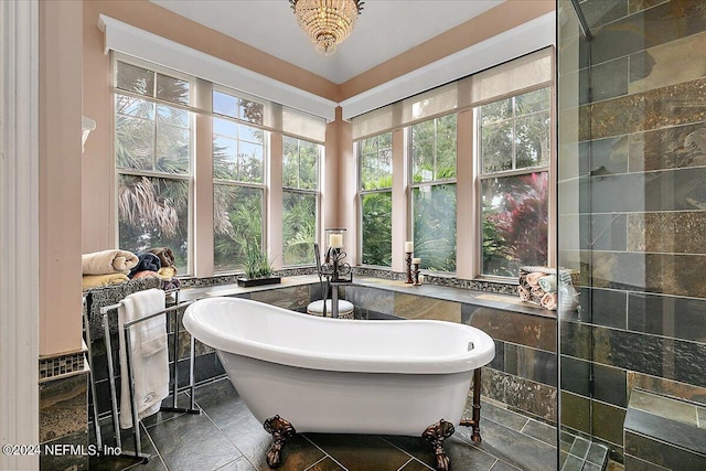 bathroom featuring a freestanding tub and tile walls