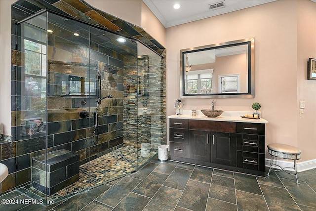 bathroom with vanity, visible vents, baseboards, a stall shower, and crown molding