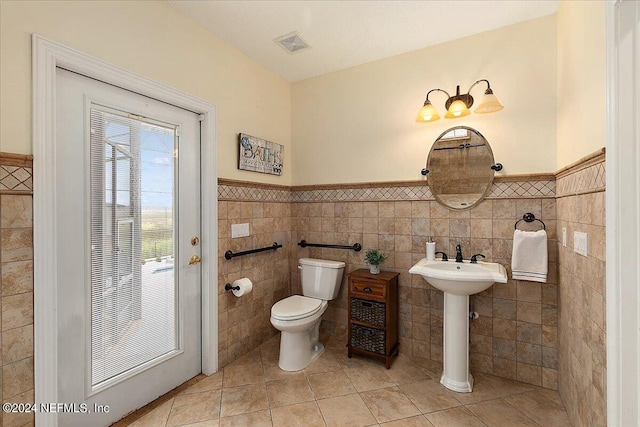 bathroom featuring wainscoting, visible vents, toilet, and tile patterned floors