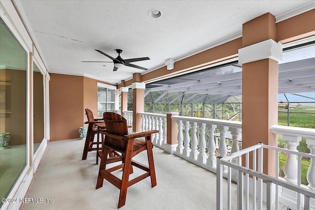 view of patio featuring a ceiling fan and a lanai