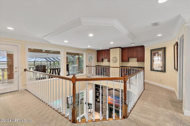 corridor with recessed lighting, light colored carpet, visible vents, ornamental molding, and baseboards