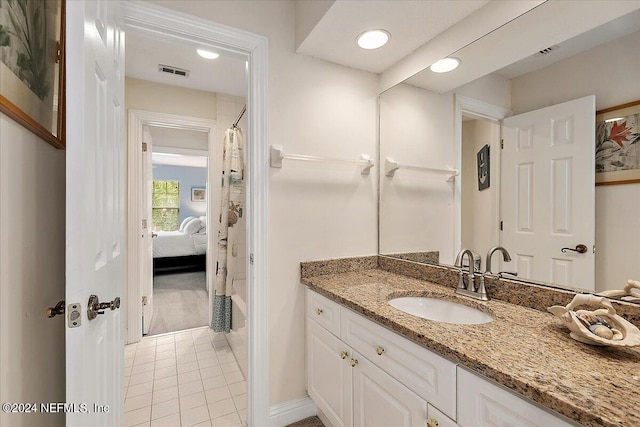 ensuite bathroom featuring tile patterned flooring, visible vents, connected bathroom, and vanity