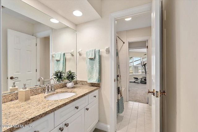 bathroom featuring recessed lighting, tile patterned flooring, vanity, and baseboards