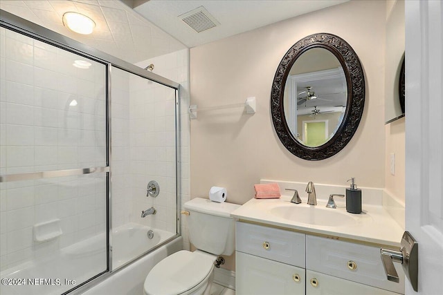 full bathroom featuring toilet, visible vents, combined bath / shower with glass door, and vanity