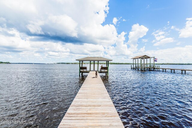 view of dock featuring a gazebo and a water view