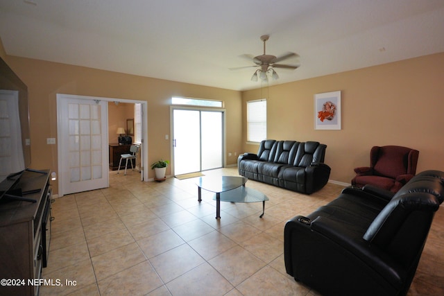 tiled living room with ceiling fan