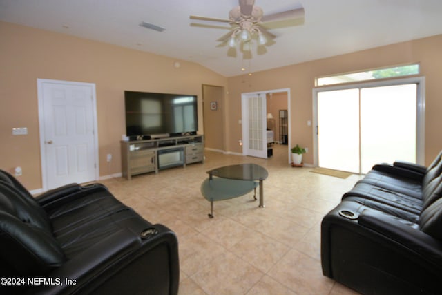 tiled living room featuring french doors, ceiling fan, and lofted ceiling