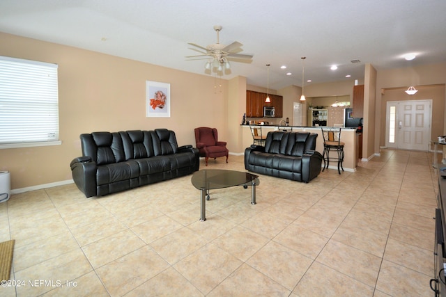 living room featuring light tile patterned flooring and ceiling fan