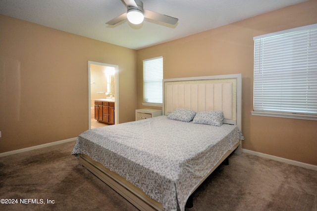 carpeted bedroom featuring ceiling fan and ensuite bath