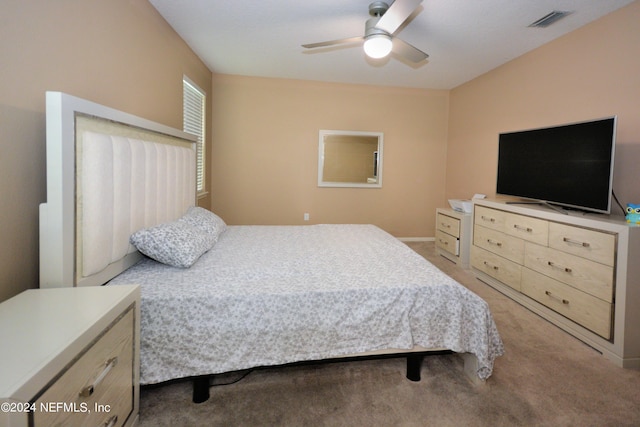 bedroom featuring light colored carpet and ceiling fan