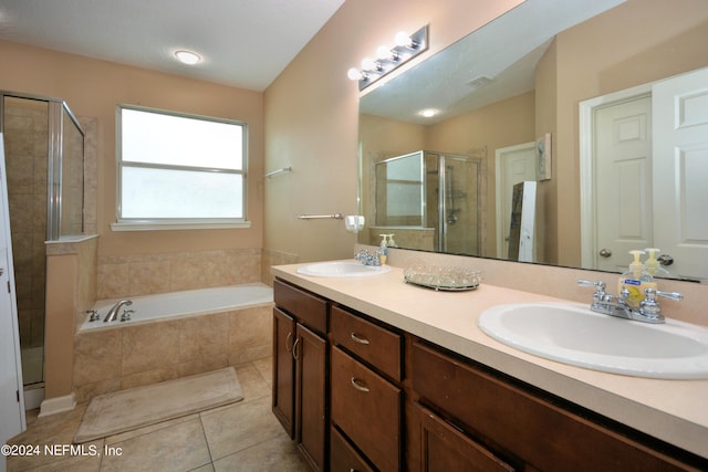 bathroom with tile patterned flooring, vanity, and shower with separate bathtub