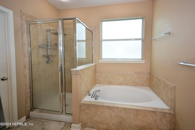 bathroom with separate shower and tub