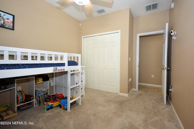 carpeted bedroom featuring ceiling fan and a closet